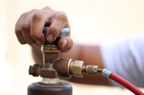 A hand of a person opening a gas tank