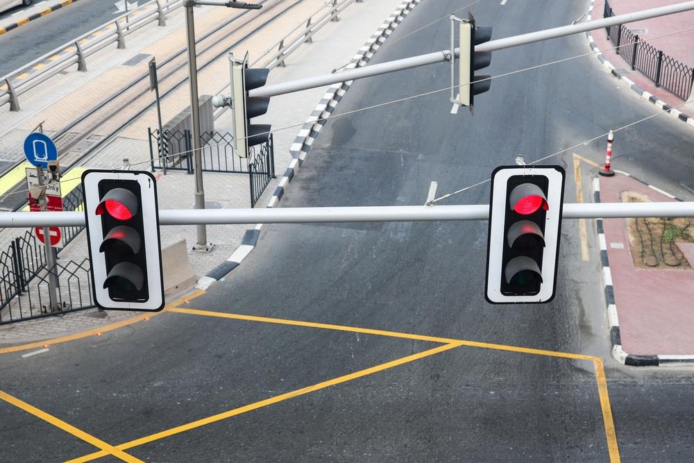 Red traffic lights over an empty intersection, representing a Philadelphia red light camera enforcement zone