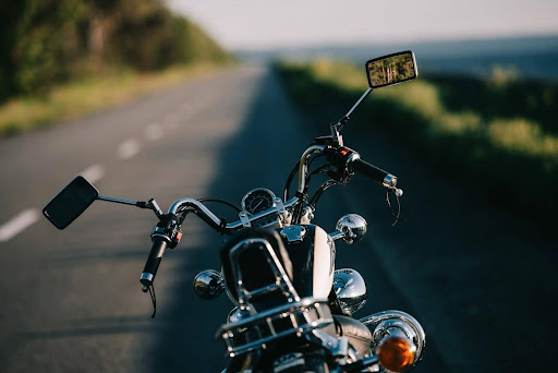 Behind the handlebars of a motorcycle on the open road.