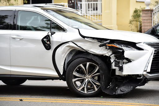 Passenger vehicle with significant front-end damage; reasons for hiring a hit and run lawyer.