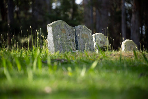 A pair of headstones in a cemetery; a wrongful death claim can help compensate for funeral costs.