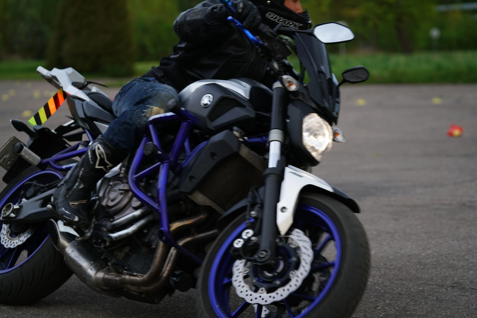 A cyclist riding a motorbike, displaying where a motorcycle crash bar or engine guard might be installed.